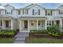 Well-manicured lawn and covered porch enhance this inviting townhome's curb appeal at 13712 Summerport Village Pkwy, Windermere, FL 34786