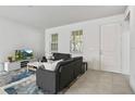 Bright living room with tile flooring, neutral paint, and comfortable seating at 13712 Summerport Village Pkwy, Windermere, FL 34786