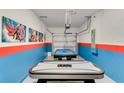 Finished garage with an air hockey table, a pool table, and wall decor at 4348 Quote St, Kissimmee, FL 34746