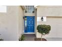 Inviting front entrance features a blue door and decorative lighting at 2134 Shadow Creek Dr, Kissimmee, FL 34746