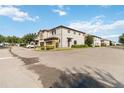 A street view showcasing several two-story townhomes, manicured lawns, and ample parking at 8541 Spyglass Ln, Davenport, FL 33896