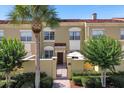 Charming two-story townhouse with a tiled roof and landscaped front yard with a privacy fence and gate at 2774 Bella Vista Dr, Davenport, FL 33897