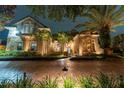 Two-story house with lights illuminating the exterior at night at 9210 Southern Breeze Dr, Orlando, FL 32836
