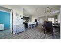 Open concept kitchen and dining area with island, stainless steel appliances, and modern light fixture at 1401 Hollow Creek Ln, Kissimmee, FL 34744