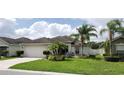 Charming single-story home featuring mature palm trees, green lawn, and a well-manicured landscape at 7139 Cedarcrest Blvd, Lakeland, FL 33810