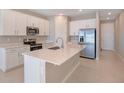 Modern kitchen with white cabinets and stainless steel appliances at 918 Heirloom Dr, Haines City, FL 33844