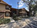 Exterior view of a condominium complex with covered entry and landscaping at 300 New Waterford Pl # 204, Longwood, FL 32779