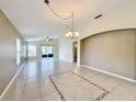 Spacious living room area with large windows and sliding doors that provide ample natural light and tile flooring at 167 Bell Tower Xing W, Poinciana, FL 34759