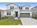 Two-story house with gray garage and landscaping at 2918 Sharp Rd, Kissimmee, FL 34744