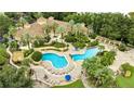 Overhead view of resort style pool, tanning chairs, landscaping and a building with a tile roof at 1100 Lake Shadow Cir # 2101, Maitland, FL 32751