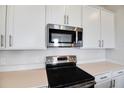 Close up of the kitchen featuring stainless steel microwave and black stovetop at 636 Hennepin Loop, Lake Wales, FL 33898