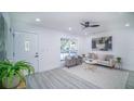 Inviting living room featuring light gray chairs, a sofa with stylish pillows, and a decorative painting at 2220 Crystal Grove Ln, Lakeland, FL 33801