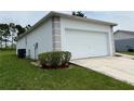 White garage with a side view showcasing a spacious design at 325 Ashley Loop, Davenport, FL 33837