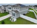 Two-story house with solar panels and fenced backyard at 592 Lake Smart Blvd, Winter Haven, FL 33881