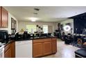 Spacious kitchen features granite counters, tile flooring, a modern faucet and dishwasher at 721 Interlude Ln # 105, Orlando, FL 32824