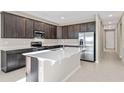 Modern kitchen with stainless steel appliances and an island at 911 Heirloom Dr, Haines City, FL 33844