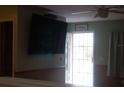 Bright living room with hardwood floors and a large TV at 267 Cranbrook Dr, Kissimmee, FL 34758