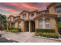 Charming townhomes feature well-maintained landscaping and a beautiful terracotta-tiled roof at 5520 Paradise Cay Cir, Kissimmee, FL 34746