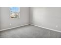 Bright bedroom with gray carpeting and neutral walls at 1706 Sugarbelle Cir, Mascotte, FL 34753