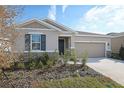 Charming one-story home with a two-car garage, and nicely landscaped yard at 1706 Sugarbelle Cir, Mascotte, FL 34753