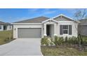 One-story house with gray siding, two-car garage, and landscaped front yard at 830 Ballantyne Dr, Lake Wales, FL 33898