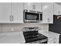 Stainless steel range and microwave in a modern kitchen at 830 Ballantyne Dr, Lake Wales, FL 33898