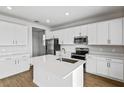 Modern kitchen with stainless steel appliances and white cabinets at 1416 Maddie Berry Ln, Kissimmee, FL 34744