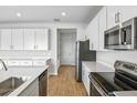 Bright kitchen features stainless steel appliances and white cabinetry at 1416 Maddie Berry Ln, Kissimmee, FL 34744