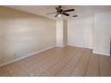 Spacious living room featuring tile floors and ceiling fan at 2060 Cypress Bay Blvd, Kissimmee, FL 34743