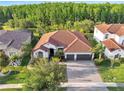 Sprawling single-story home with tile roof, three car garage and private backyard close to nature preserve at 2891 Swoop Cir, Kissimmee, FL 34741