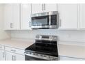 Stainless steel range and microwave in a modern kitchen setting at 883 Griffon Ave, Lake Alfred, FL 33850