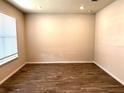 Bright, spacious room features wood-look flooring and a large window that allows natural light to stream in at 4520 Gliding Wave St, Winter Garden, FL 34787