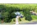 Beautifully landscaped home with a brick driveway and mature trees in a quiet neighborhood at 14121 Bella Ln, Orlando, FL 32832