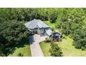 Stunning two-story home with a neutral color palette, mature landscaping, and a brick driveway at 14121 Bella Ln, Orlando, FL 32832