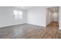 Bright and airy living room with wood-look tile flooring at 1634 Sugarbelle Cir, Mascotte, FL 34753