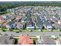 An aerial view shows a residential neighborhood with well-maintained homes, streets, and landscaping at 1862 Beach Ridge Rd, Celebration, FL 34747