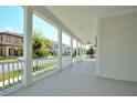 Covered front porch with white columns and view of neighborhood at 1862 Beach Ridge Rd, Celebration, FL 34747