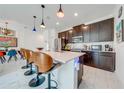 Modern kitchen with dark cabinetry, stainless steel appliances, and a large island at 4222 Paragraph Dr, Kissimmee, FL 34746