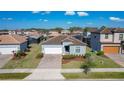 Aerial view of a single-Gathering home with a brick driveway, two-car garage, and well-maintained landscaping at 185 Brookes Pl, Haines City, FL 33844