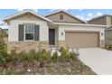 Newly built home with stone accents and a two-car garage at 3345 Chicory Ct, Lake Hamilton, FL 33851