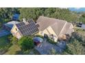 Inviting home exterior with solar panels, a spacious driveway, and lush landscaping, perfect for a sustainable lifestyle at 19529 Dorr Rd, Altoona, FL 32702