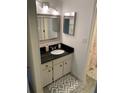 Bright bathroom with updated vanity, granite countertop, decorative mirror and neutral decor at 2647 Surrey Ct # 2647, Kissimmee, FL 34741