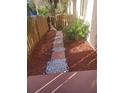 Front walkway adorned with mulch, white gravel, pavers, and lush greenery at 2647 Surrey Ct # 2647, Kissimmee, FL 34741