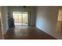 Bright living room featuring wood flooring, sliding glass doors, and backyard access at 2647 Surrey Ct # 2647, Kissimmee, FL 34741