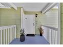 Inviting condo entrance with a well-lit porch and decorative potted plants at 3145 Britannia Blvd # D, Kissimmee, FL 34747