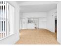 Open concept living room with kitchen, tile floors, neutral walls, and natural light at 2217 Grand Cayman Ct # 1233, Kissimmee, FL 34741