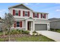 Charming two-story home with red shutters and landscaped front yard, enhancing curb appeal at 1647 Sugarbelle Cir, Mascotte, FL 34753