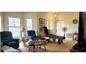 Cozy living room with comfortable seating, large windows, and an inviting atmosphere at 9549 Sw 53Rd Cir, Ocala, FL 34476