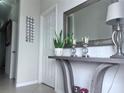Close-up of a stylish foyer table with lamps, a mirror, and decorative accents at 8118 Platts Ave, Orlando, FL 32832