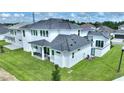 Two-story home with gray roof, white exterior, and a private backyard at 107 Hampton Loop, Davenport, FL 33837
